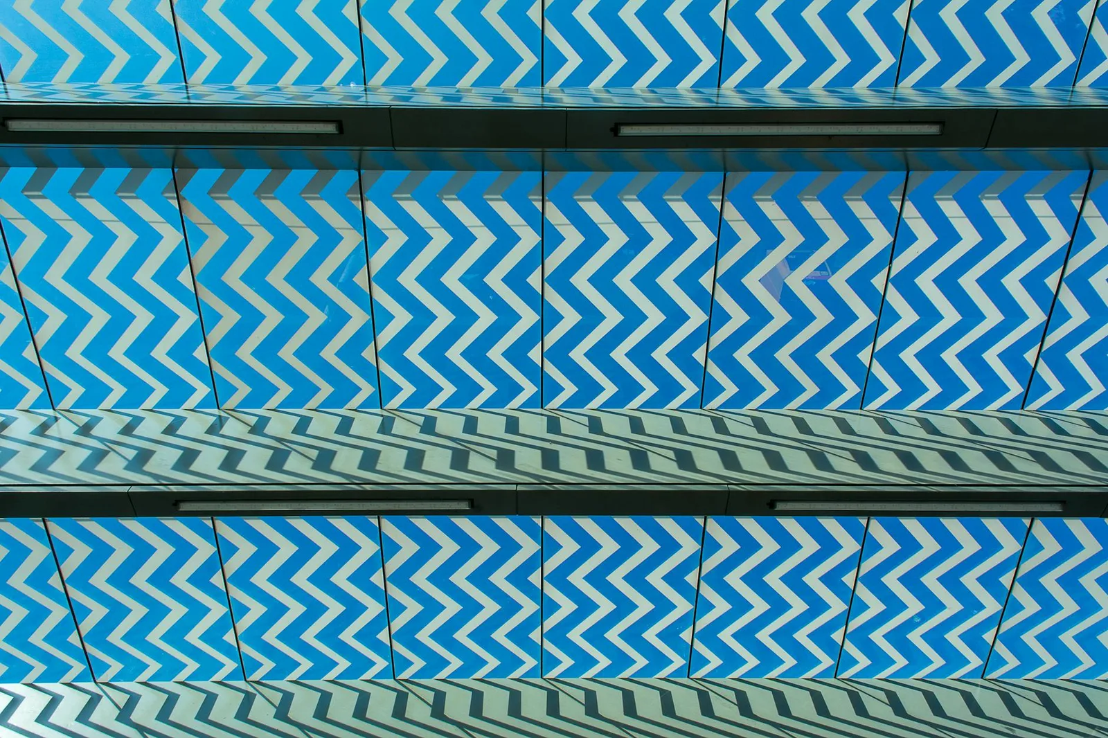 Ceremonial Security: Controls Your Team Performs But Nobody Measures — A captivating zigzag pattern in blue on a modern archi…